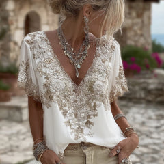 Damska koszulka z krótkim rękawem i dekoltem w serek, wykonana z mieszanki lnu i ozdobiona haftowanymi kwiatami