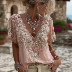 Damska koszulka z krótkim rękawem i dekoltem w serek, wykonana z mieszanki lnu i ozdobiona haftowanymi kwiatami